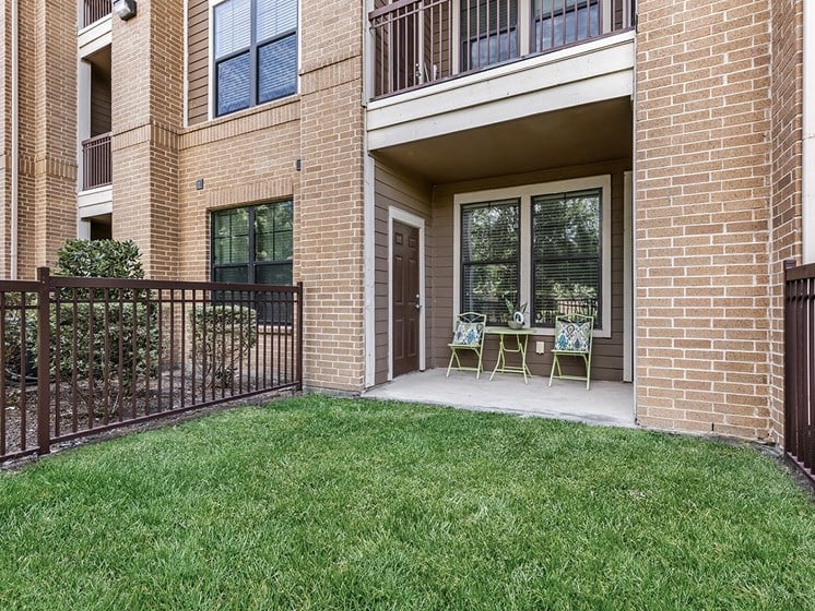our apartments offer a patio with chairs and a lawn